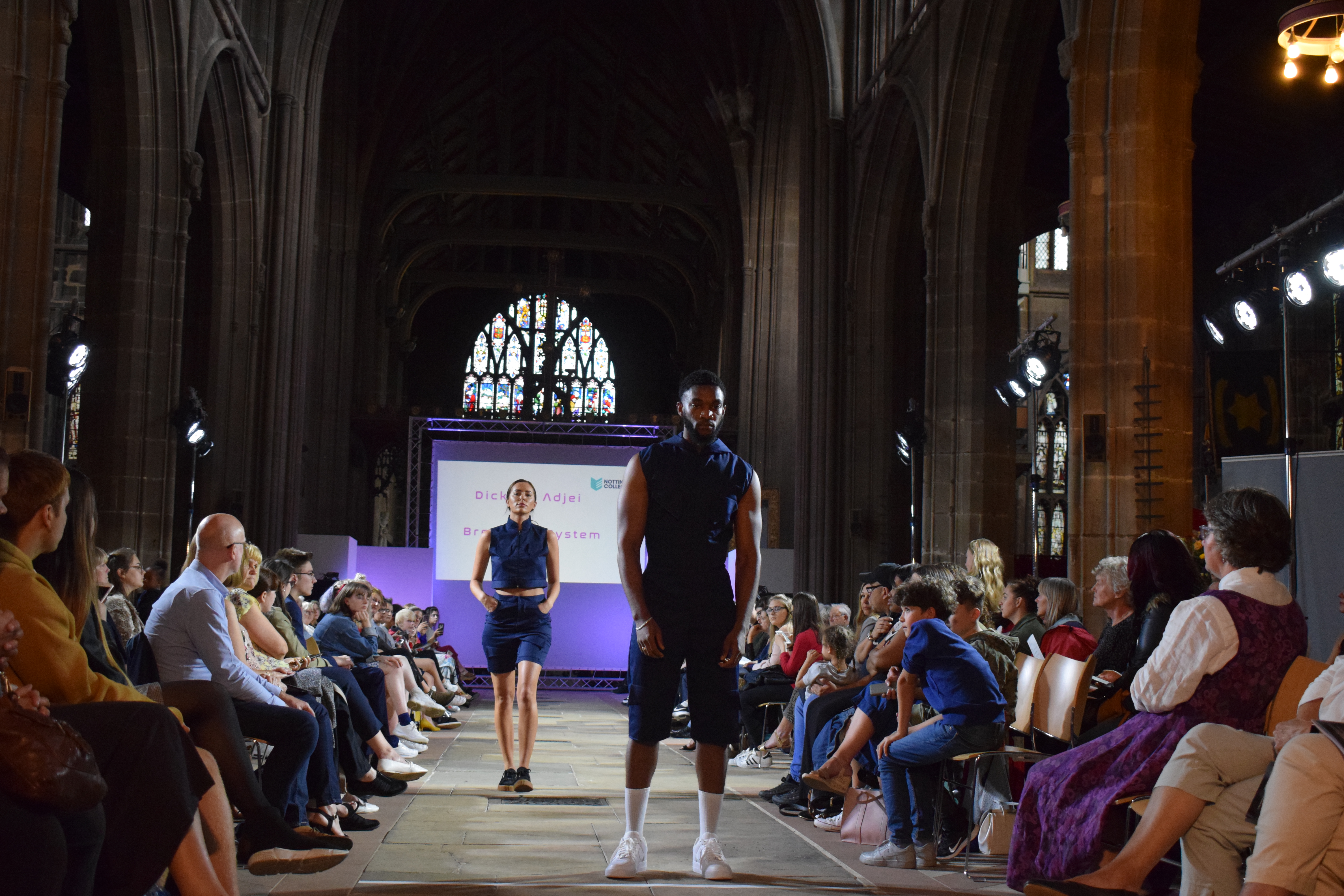 2 students walking down the catwalk at St Mary's Church