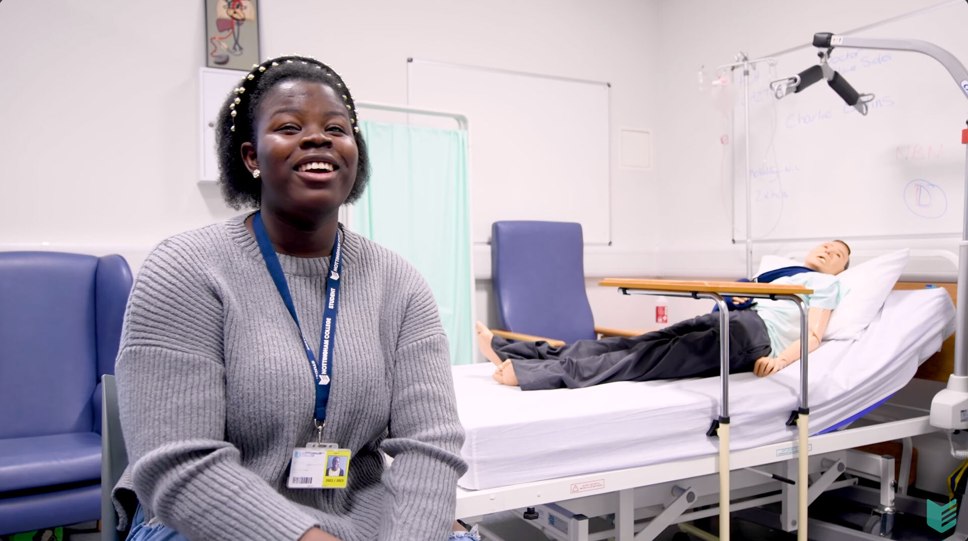 A student sitting by a hospital bed in our City Hub.