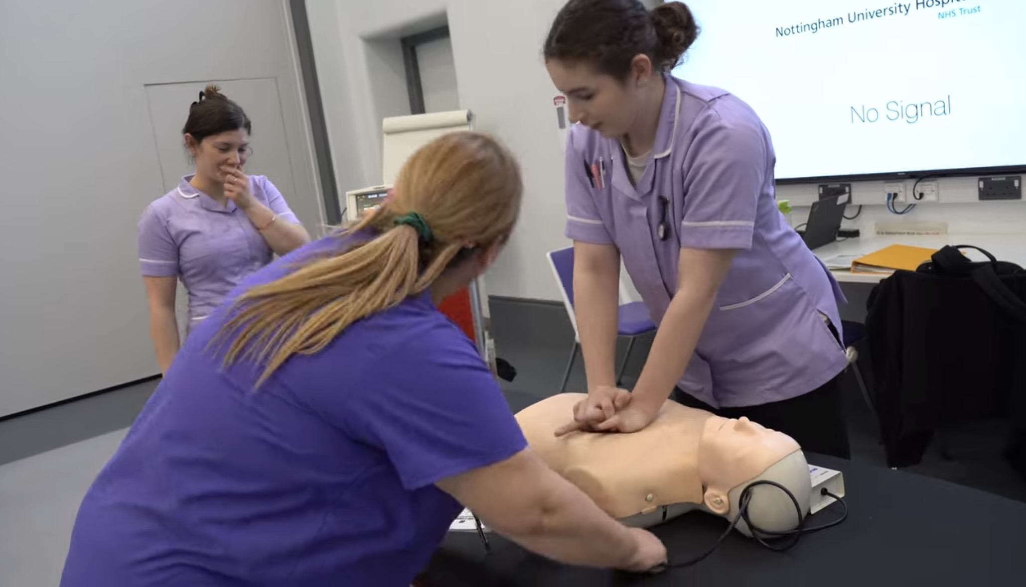 Students practicing CPR on a dummy
