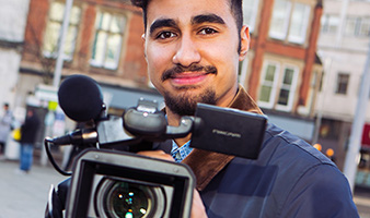 A student behind a video camera