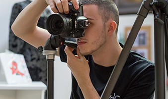 A student taking a photograph in a studio