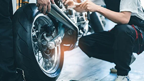 Two students working on a motorbike