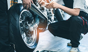 Two students working on a motorbike