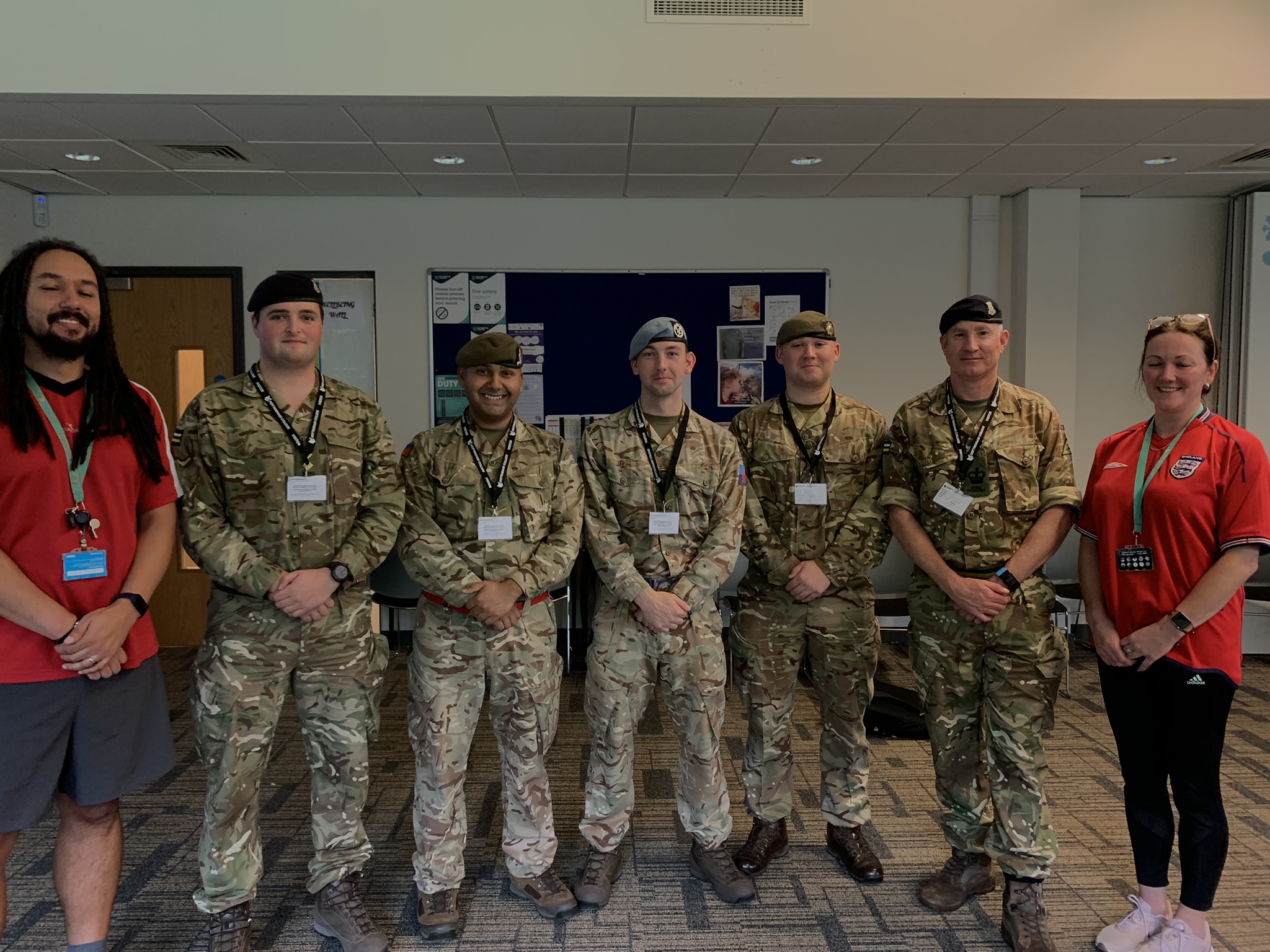 Students and staff with members of the army