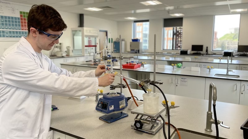 A student working in a science laboratory.