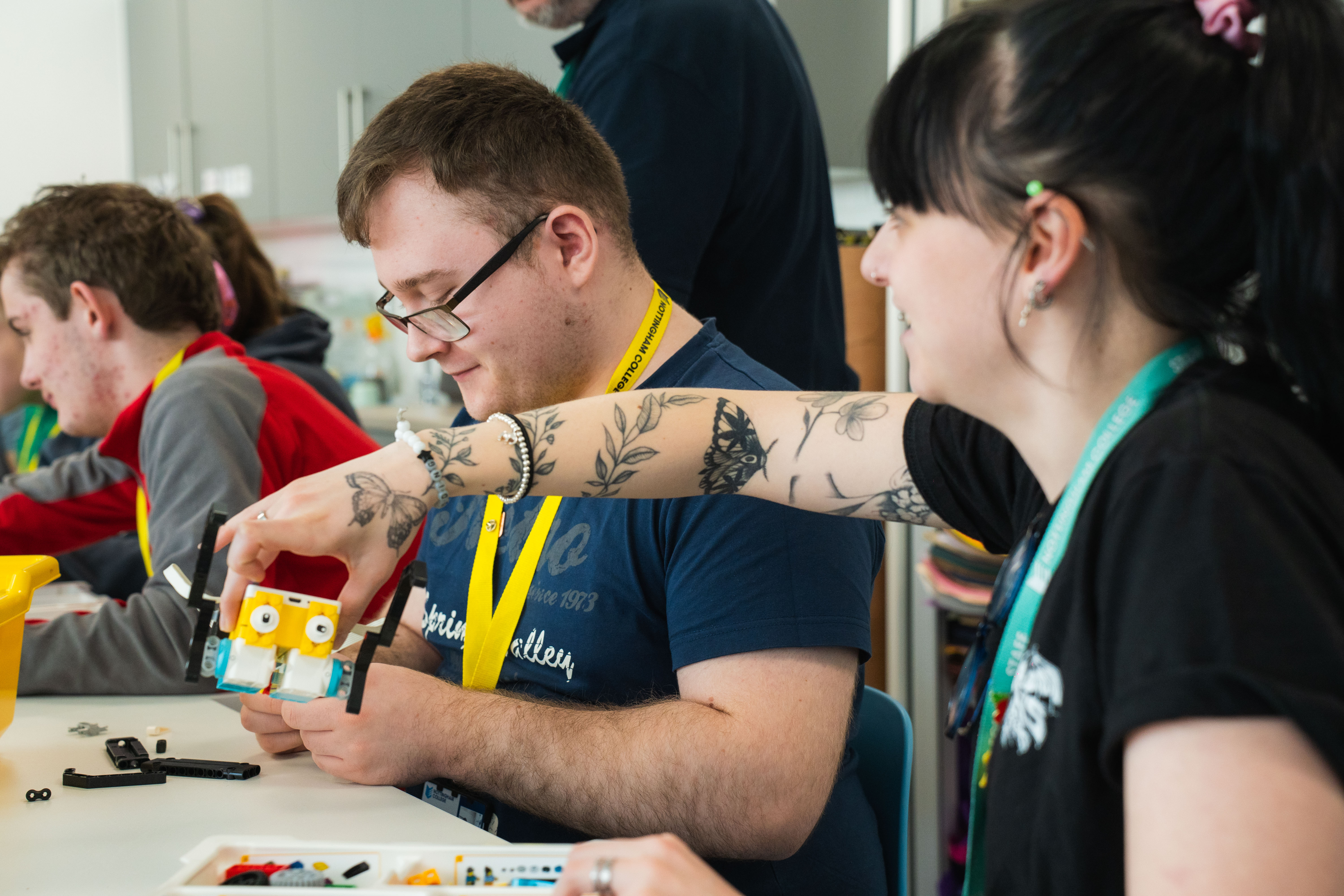 Staff member helping student with Lego project