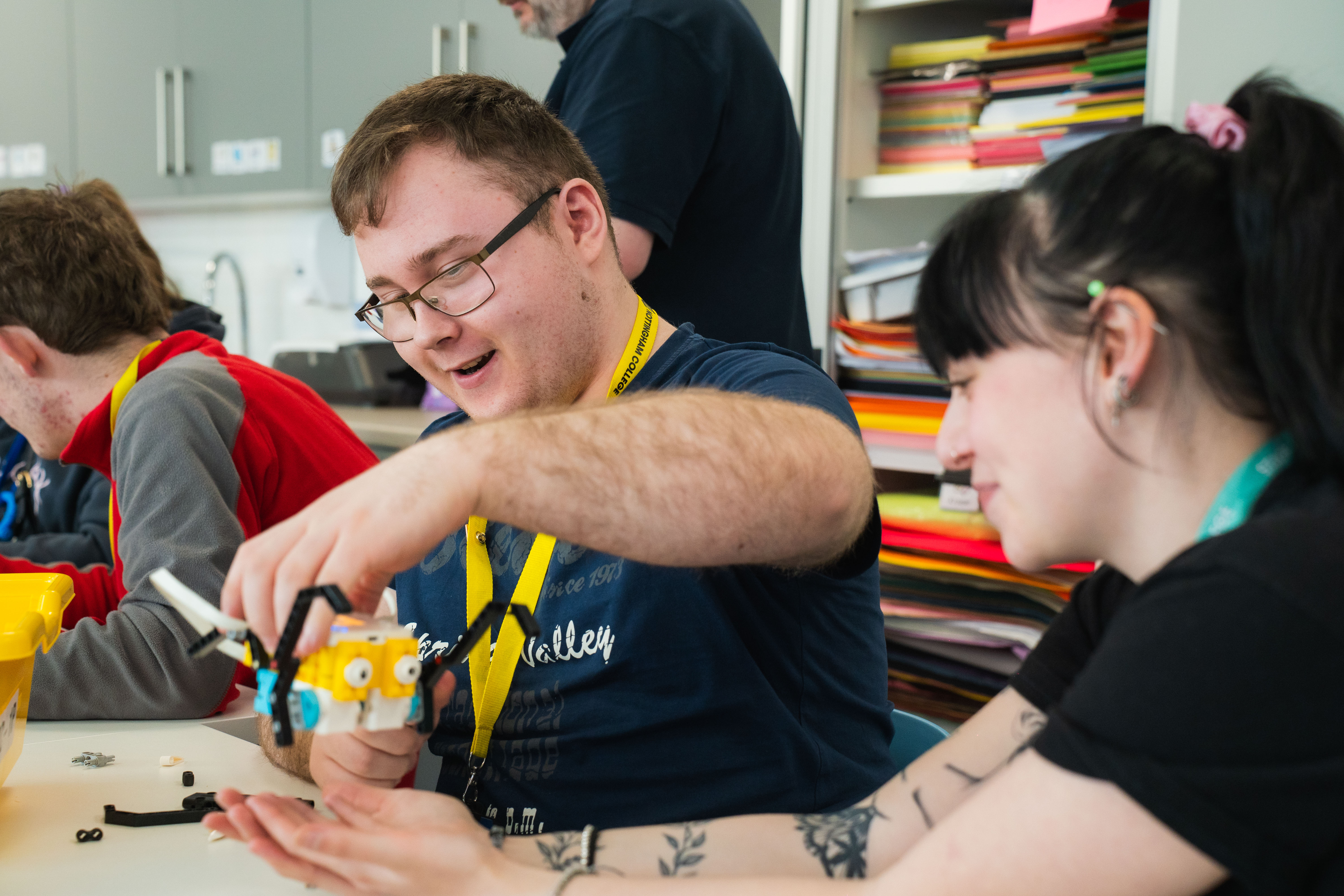 Student adjusting parts on lego robot
