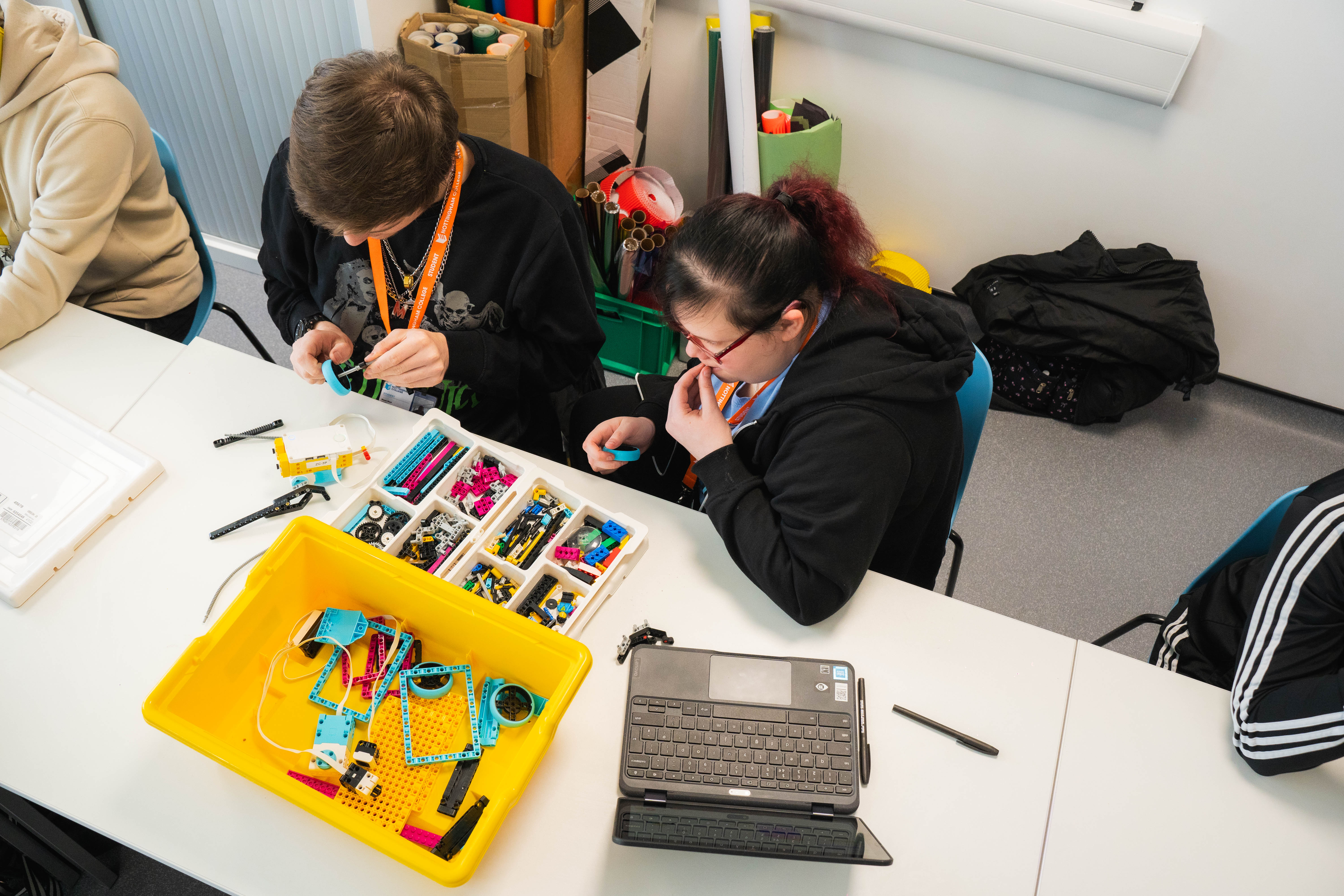 Students replacing parts on lego project