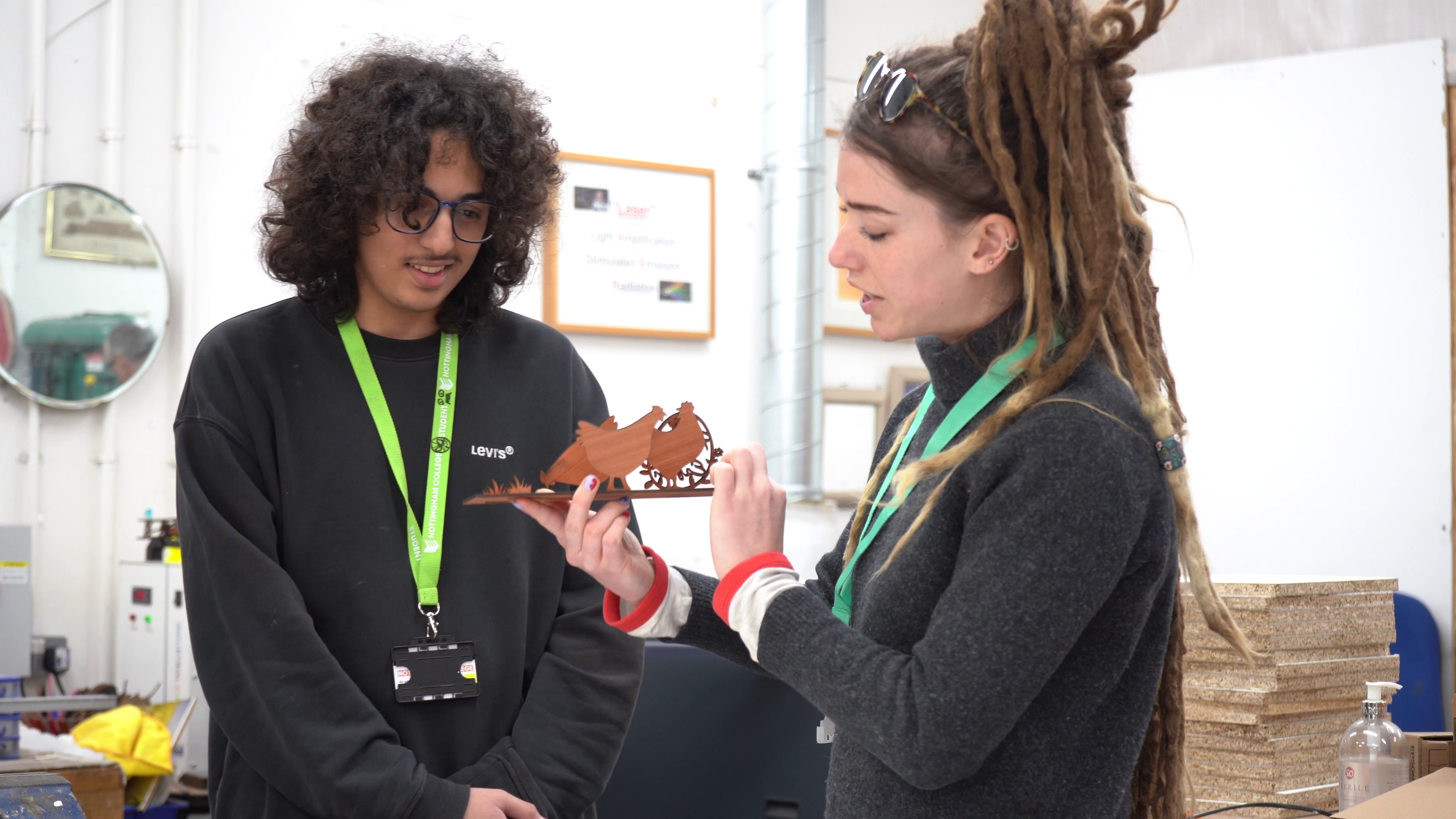 Teacher explaining a wooden model to a student