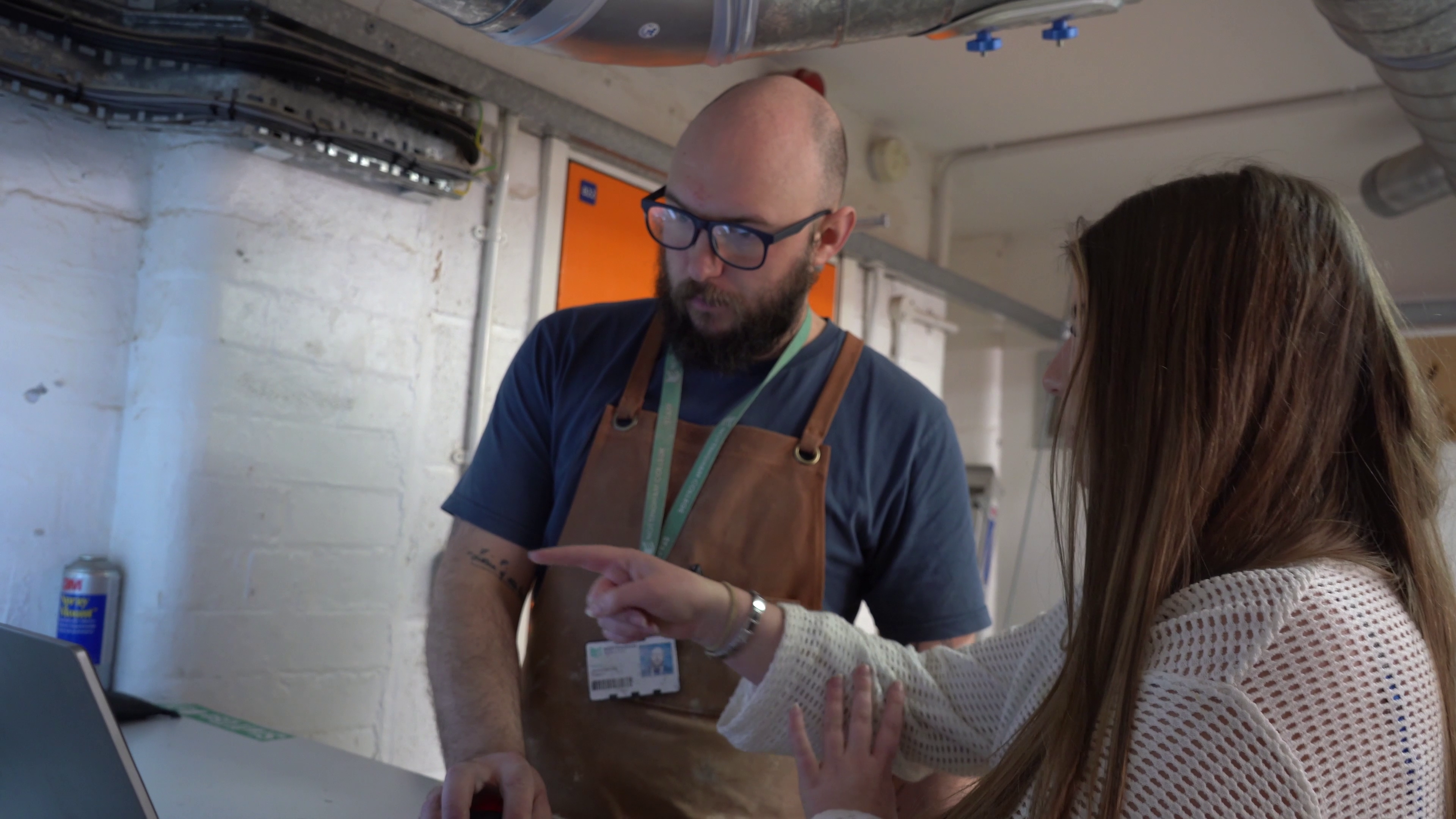 Tutor showing a student how a piece of equipment works