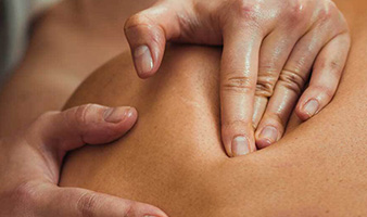 A person performing an aromatherapy massage