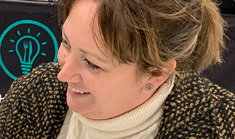 A member of staff smiling