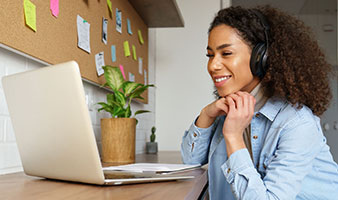 A female student at home learning on her laptop