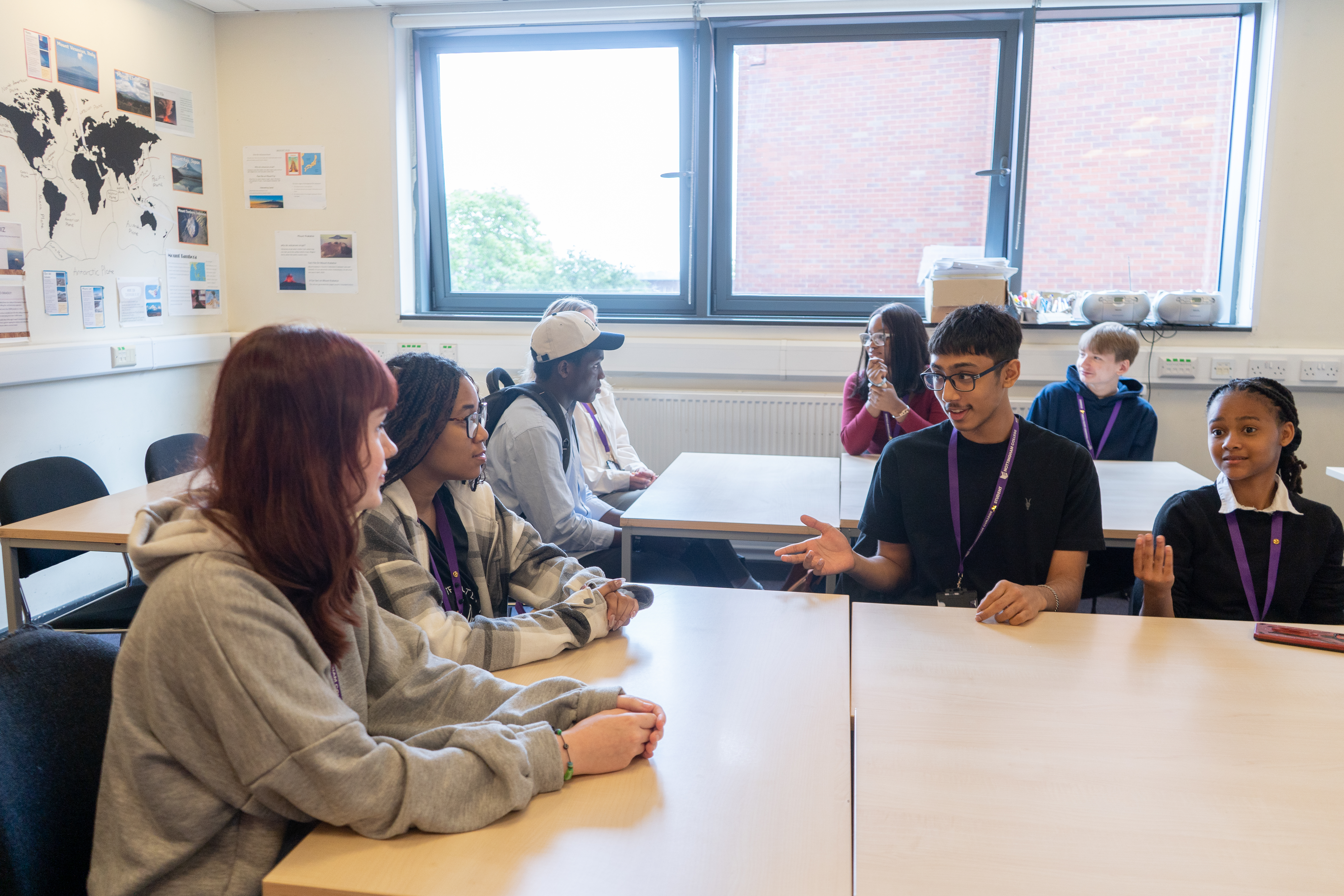 A Level students in around a table in a discussion