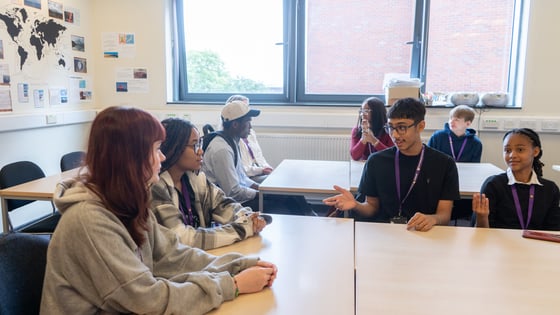 A Level students in around a table in a discussion