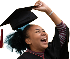 A student holding her mortar board and smiling