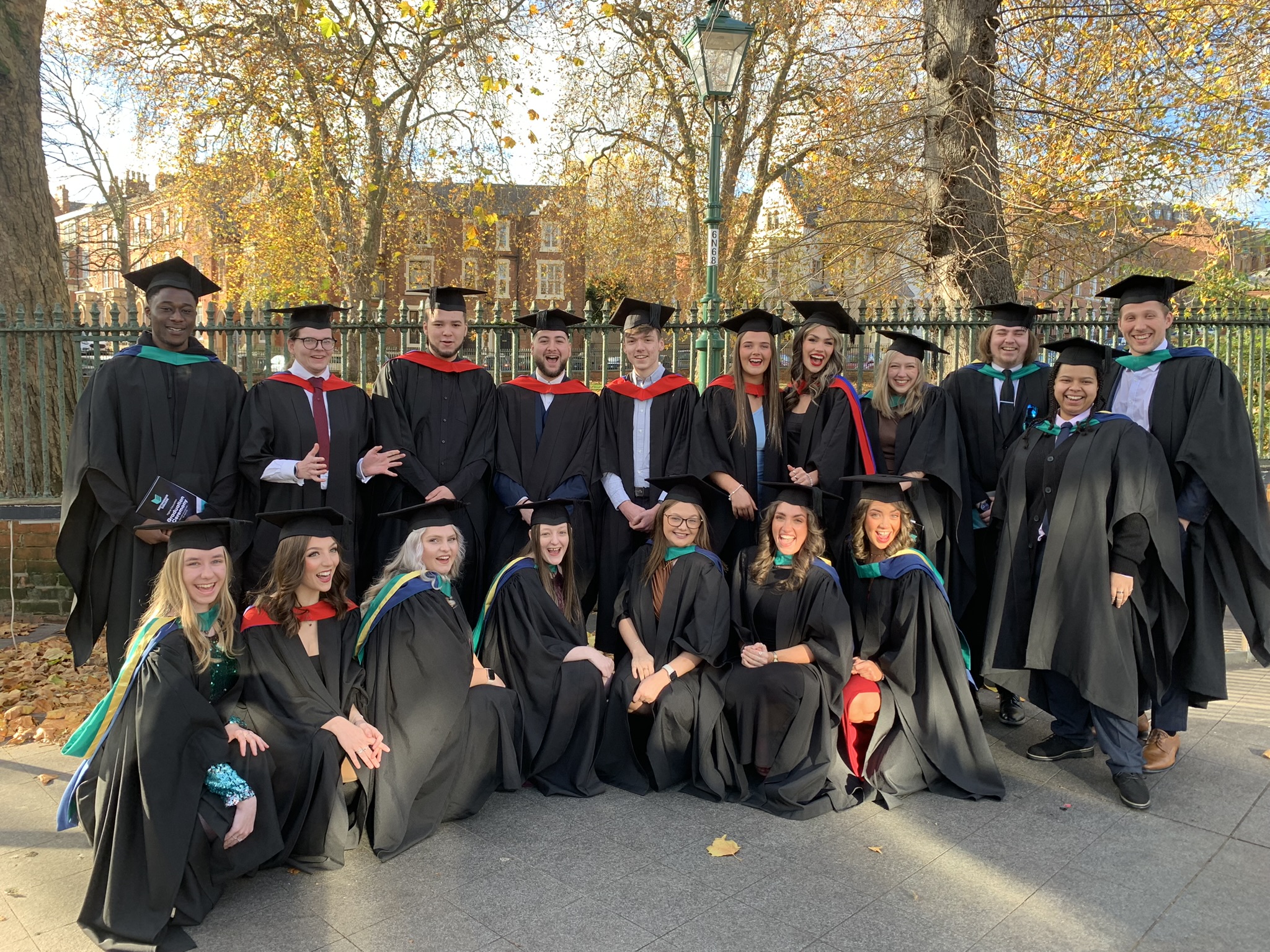A large group of graduating students and their tutors posing for a photo