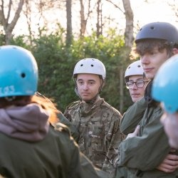 Students on a training excerse in a wooden forest