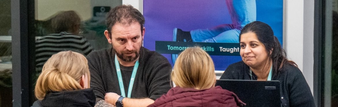 Visitors at an open event talking to staff