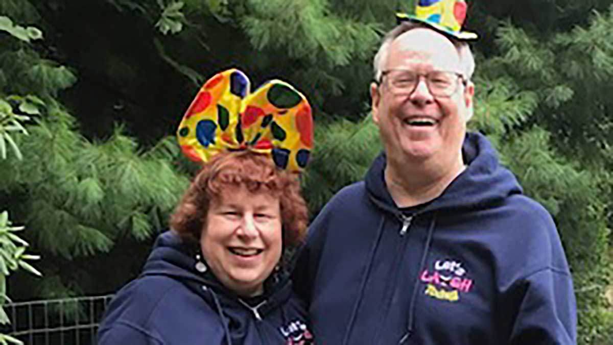 Bill and Linda Hamaker wearing funny hats and smiling