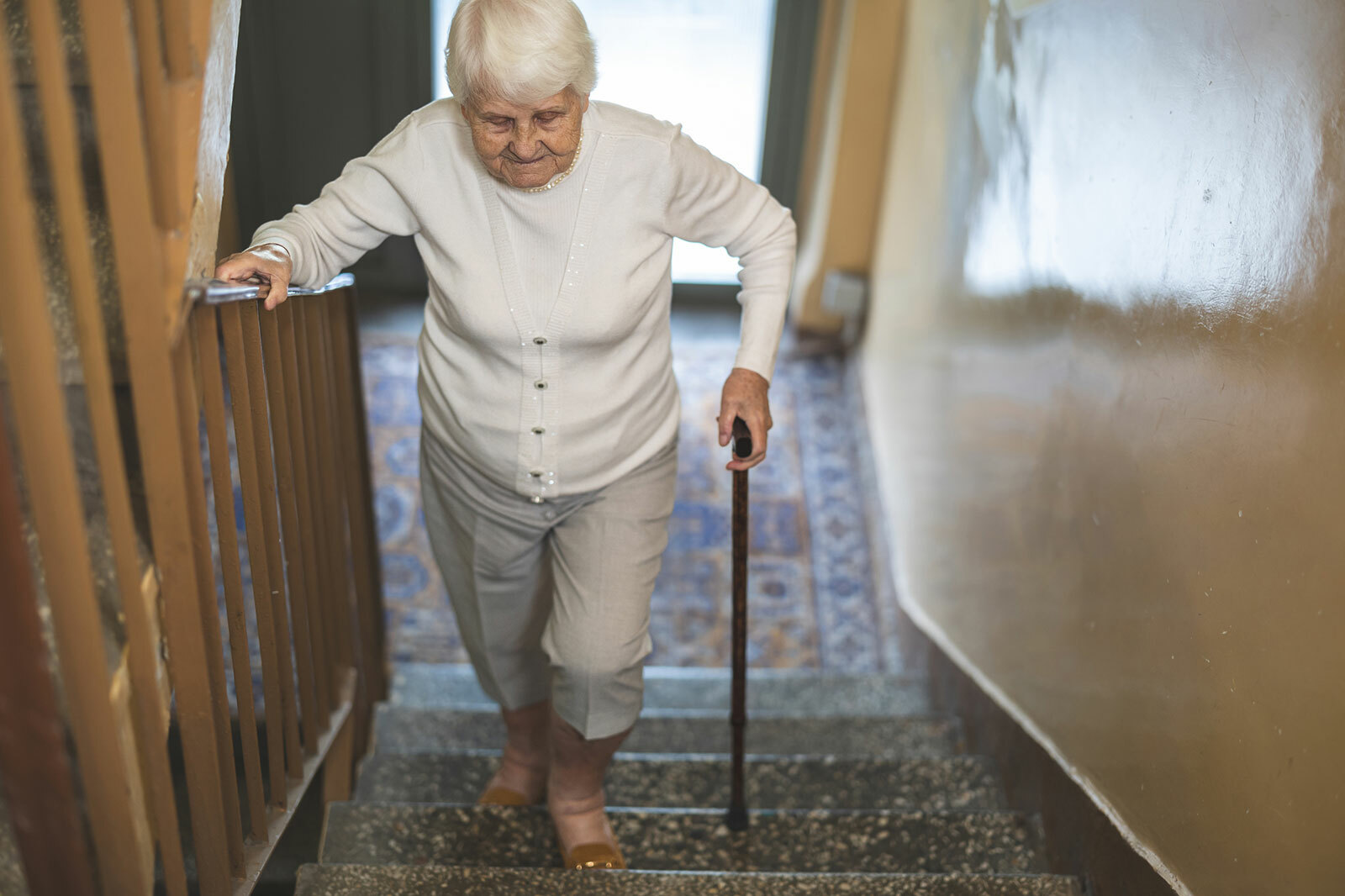 Older adult woman on stairs
