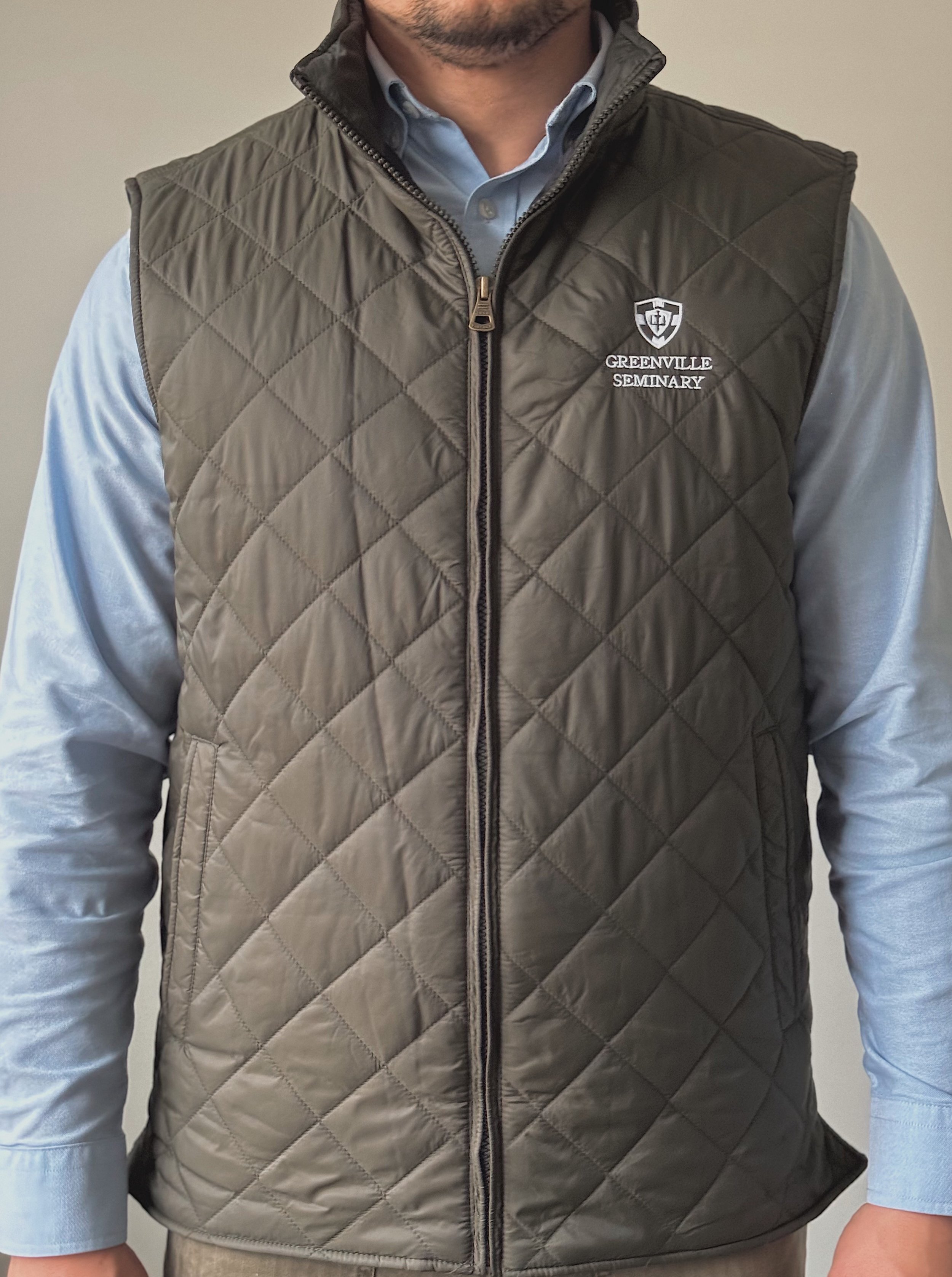 Quilted vest featuring the Greenville Seminary embroidered logo on the left chest.