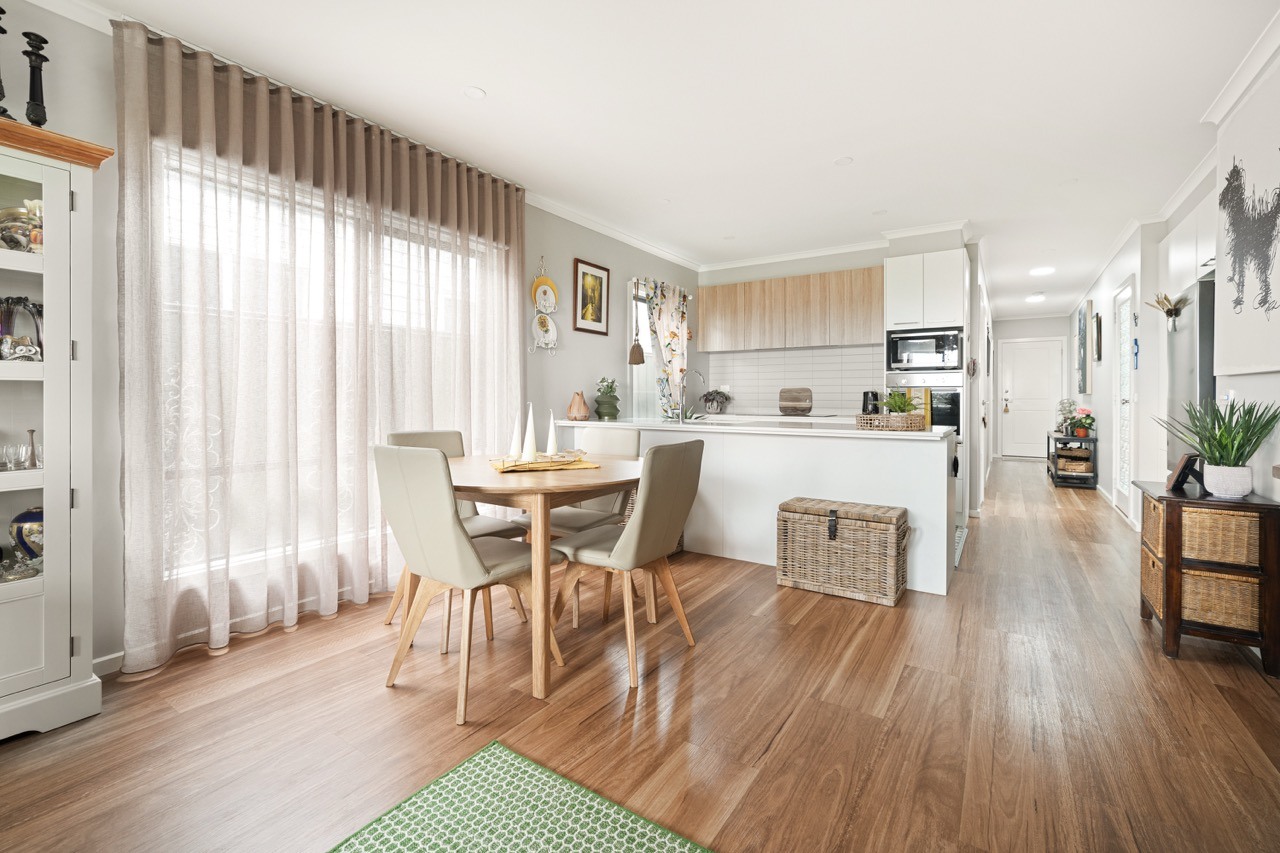 Bright open-plan kitchen and dining area with modern finishes in a Lifestyle Communities home.