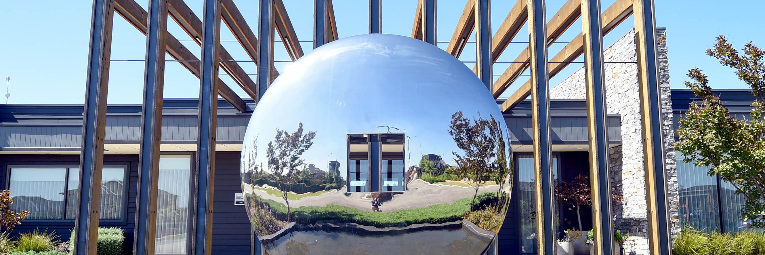 Mirrored sphere sculpture in water feature at Lifestyle Berwick Waters, Melbourne