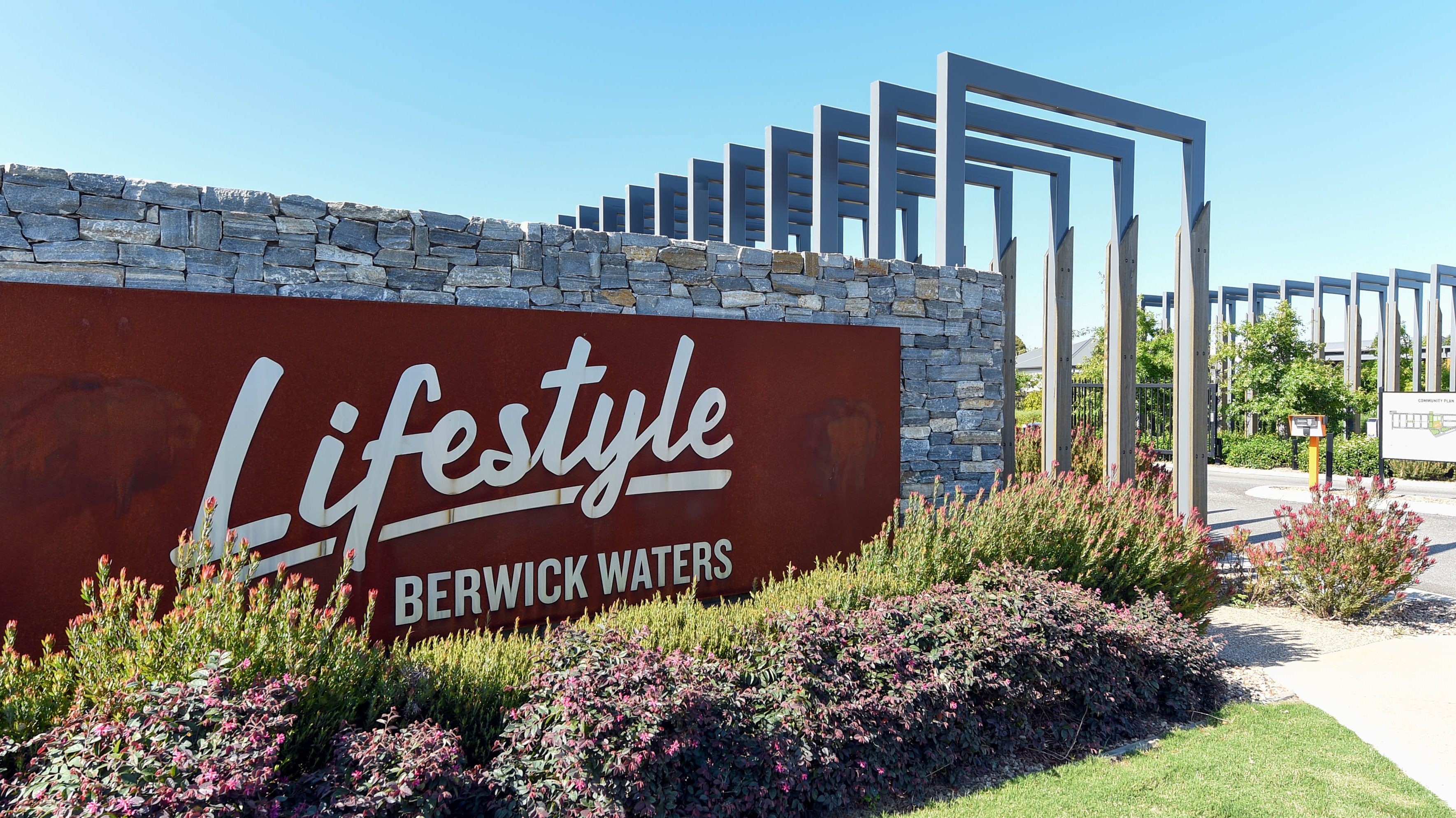 Lifestyle Berwick Waters entrance sign, featuring stone and metal design.