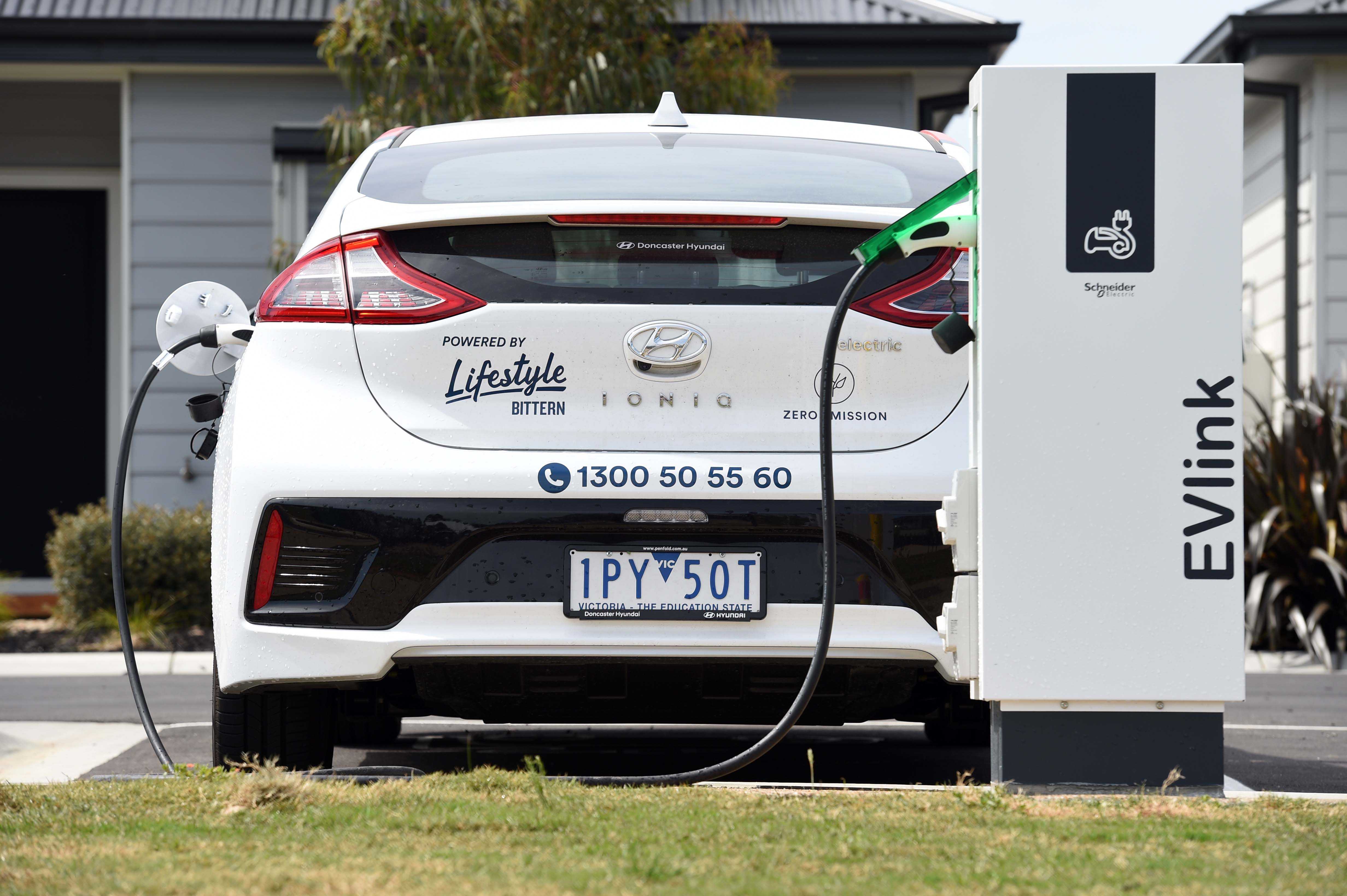 electric car charging at a ev electric station in a liferstyle community property