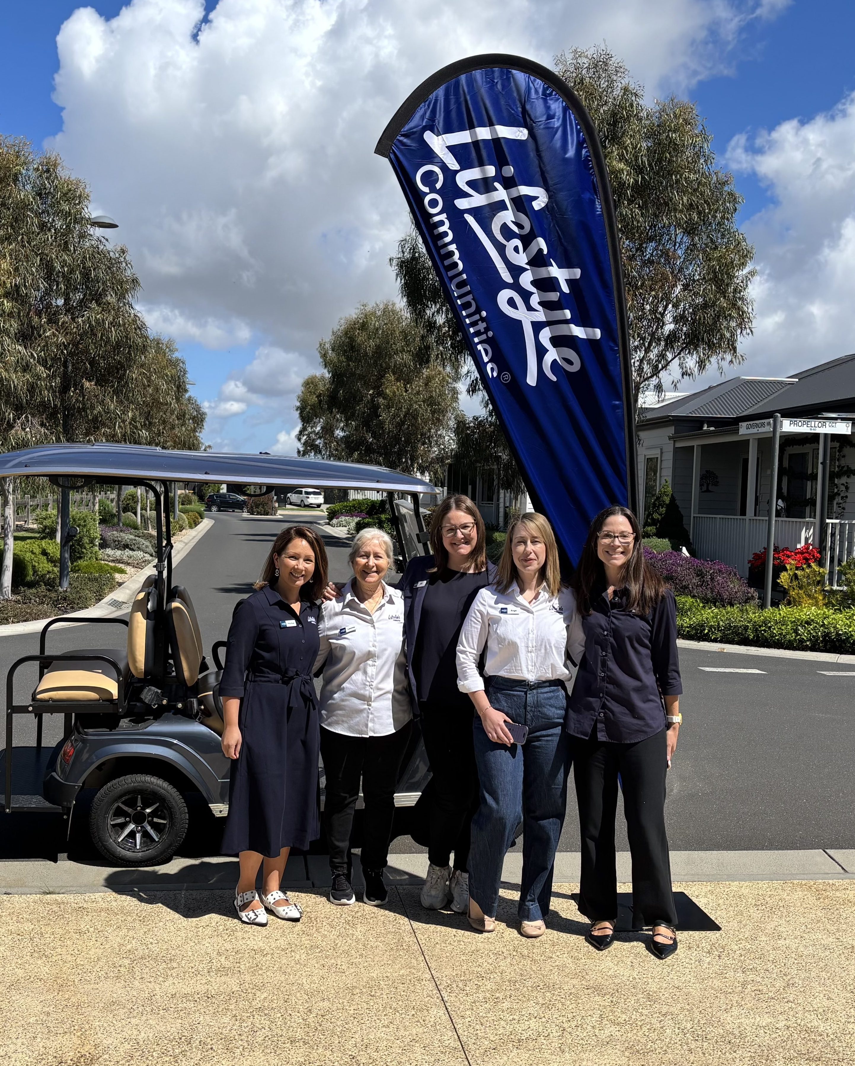Lifestyle Communities team member warmly greeting residents during a clubhouse event.