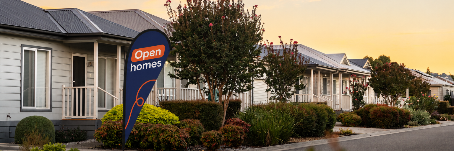 Display homes at Lifestyle Communities Officer with landscaped gardens, tree-lined streets, and an open homes sign at sunset.