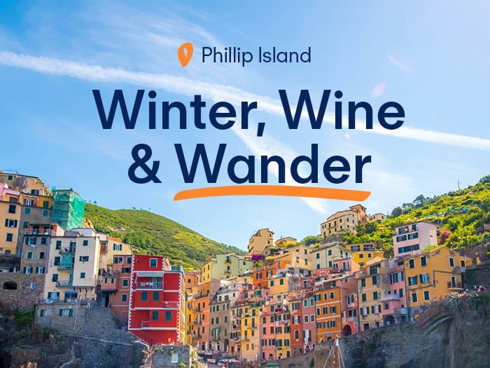 Winter Wine and Wander event banner for Phillip Island Lifestyle Communities featuring a coastal hillside town with colourful houses