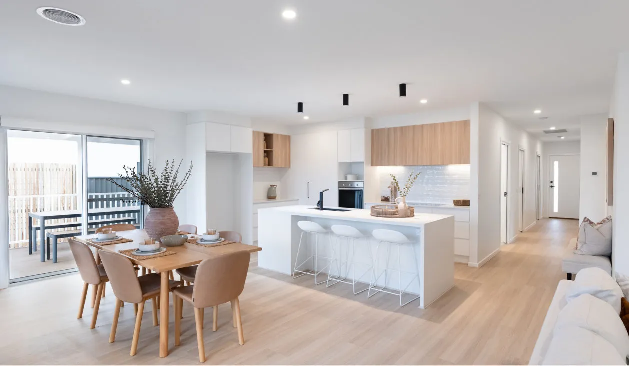 Open-plan kitchen and dining area in a modern Lifestyle Communities home.