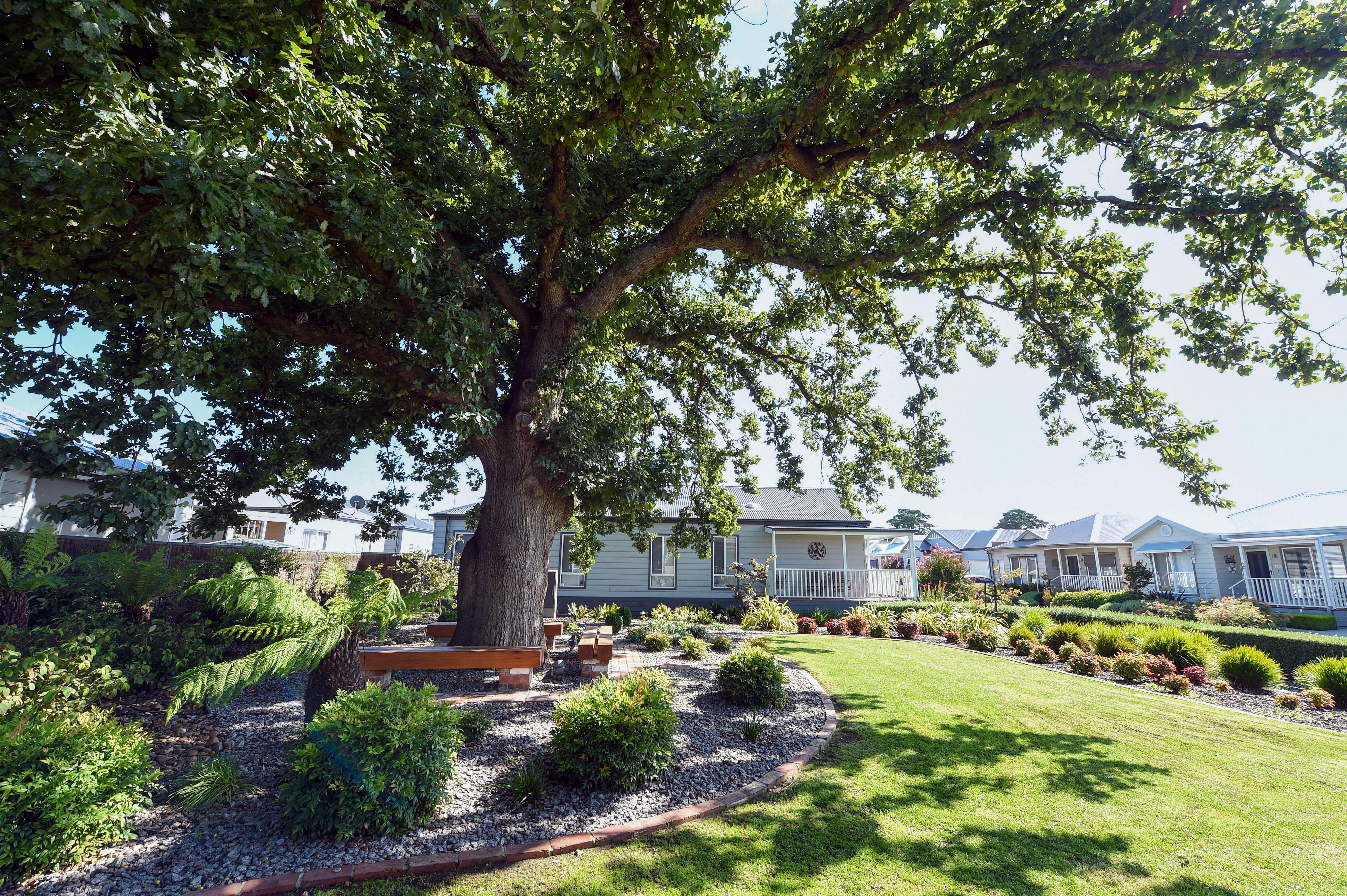 Lifestyle Officer residential streetscape with homes and landscaping.