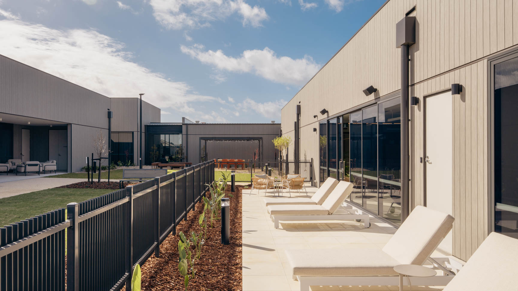 Outdoor relaxation area with lounge chairs and landscaped garden at Lifestyle St Leonards.