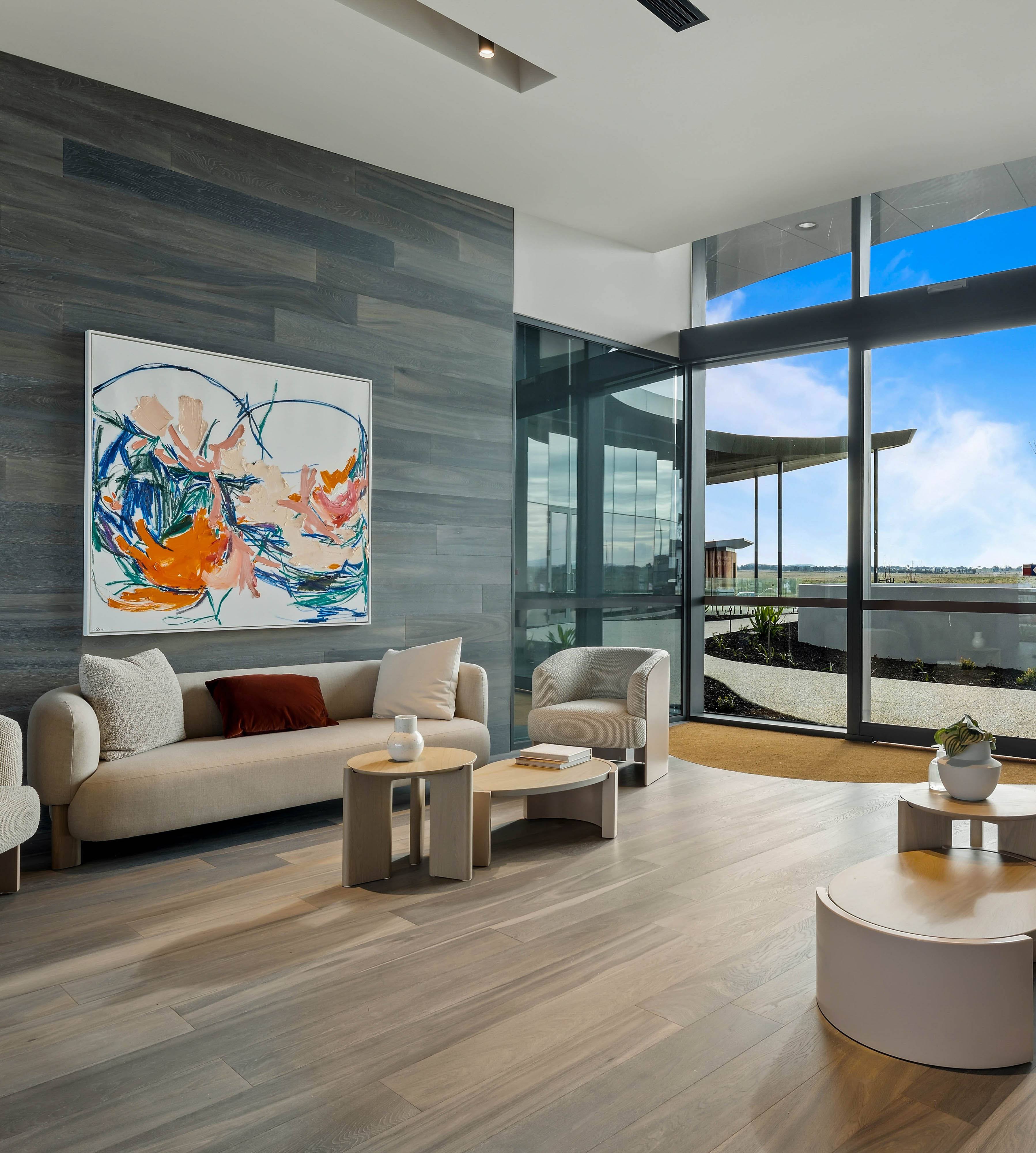 Contemporary lounge area inside Lifestyle Wollert clubhouse with artwork and large windows.