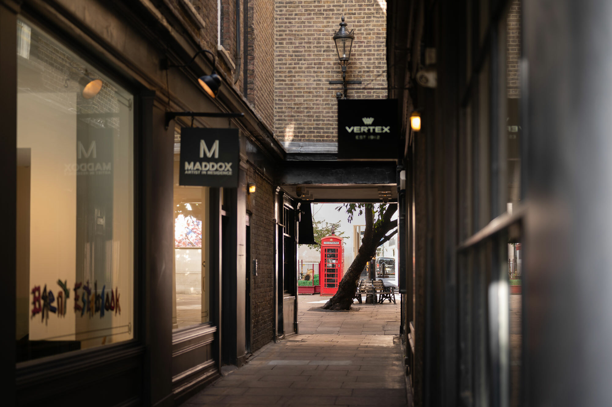 A close of view of shops in Mayfair with red telephone box in distance.