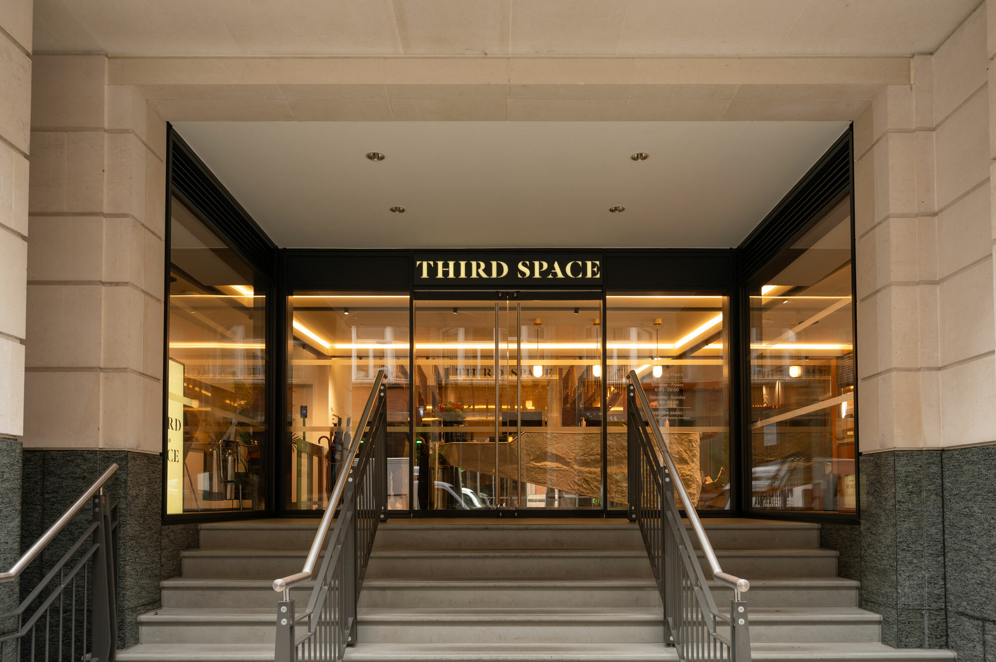 Front view of Third Space Club with stairs and full heigh windows.