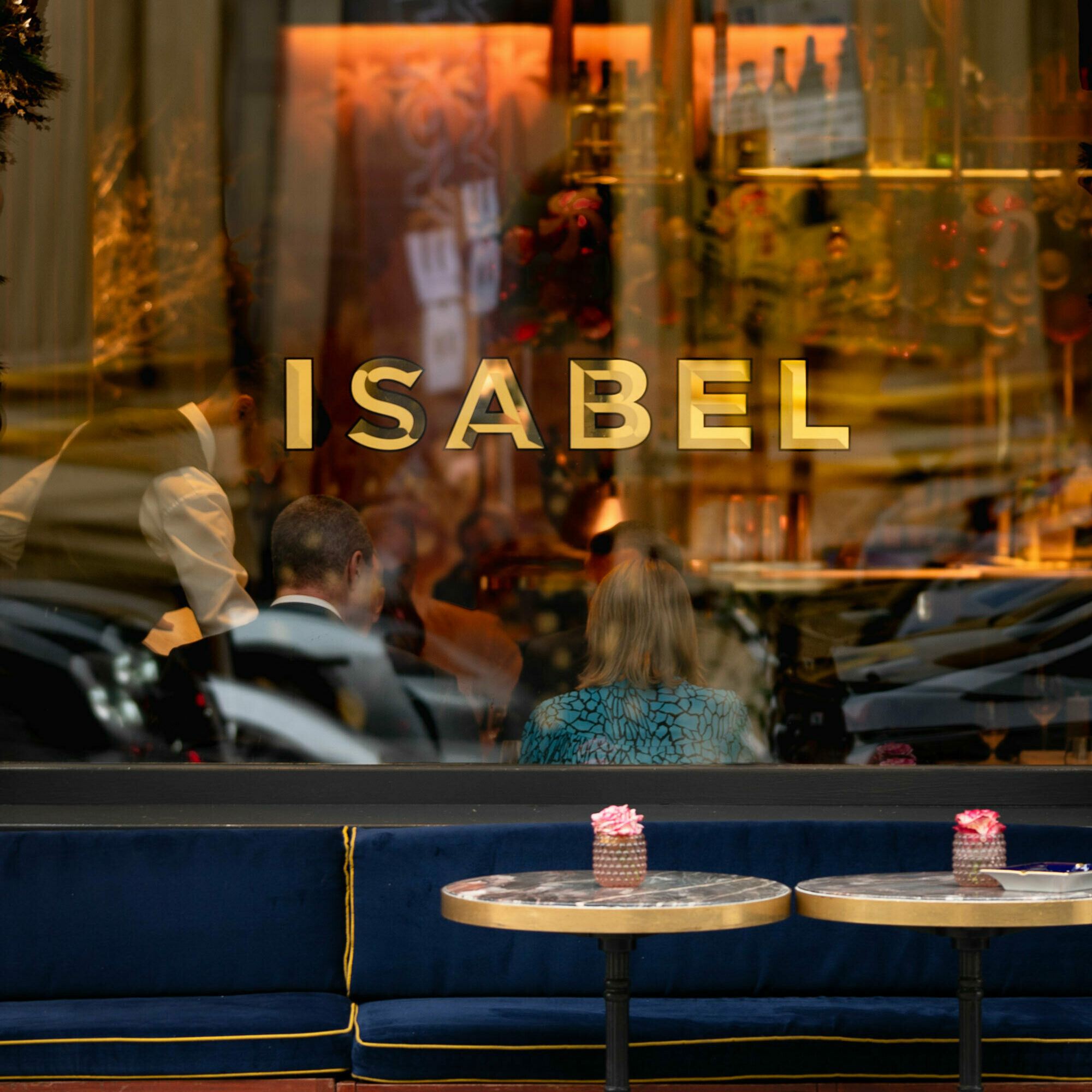 A close up window view of Isabel restaurant in Mayfair.