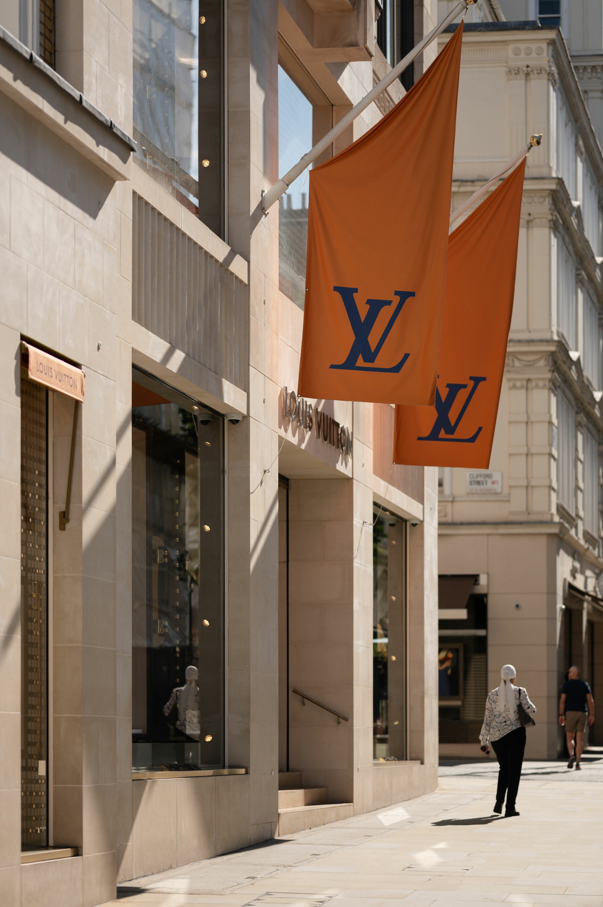 Louis Vuitton shop front with 2 large branded flags.