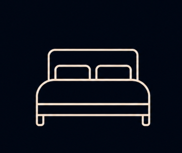 Gold line icon of a double bed with headboard and two pillows on a dark navy background.