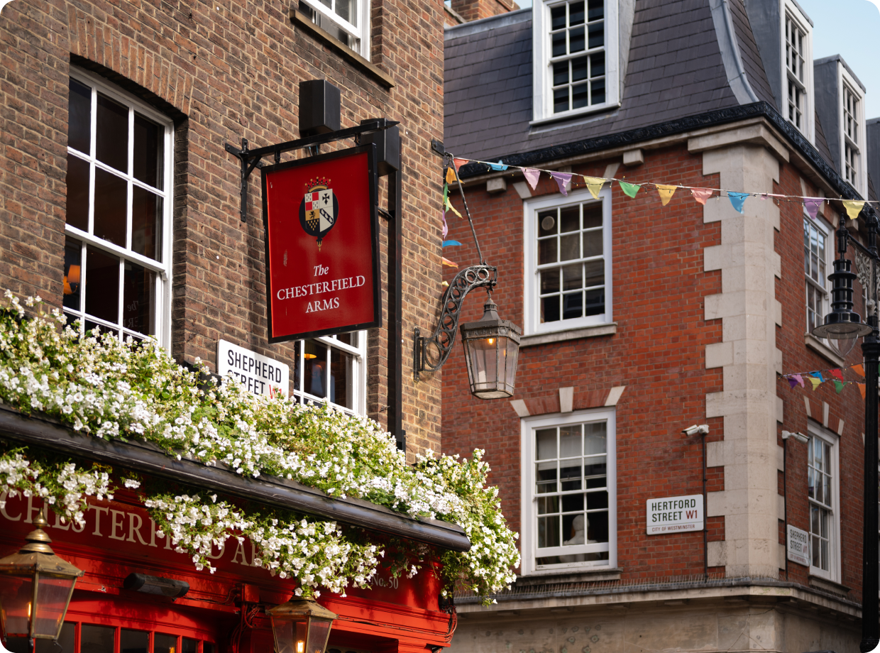 view of shepherd street looking up at the sign for the chesterfield arms pub