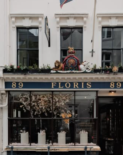 Floris shop front at 89 Jermyn Street, London. Navy blue fascia, royal coat of arms above, white Georgian facade and window displays.