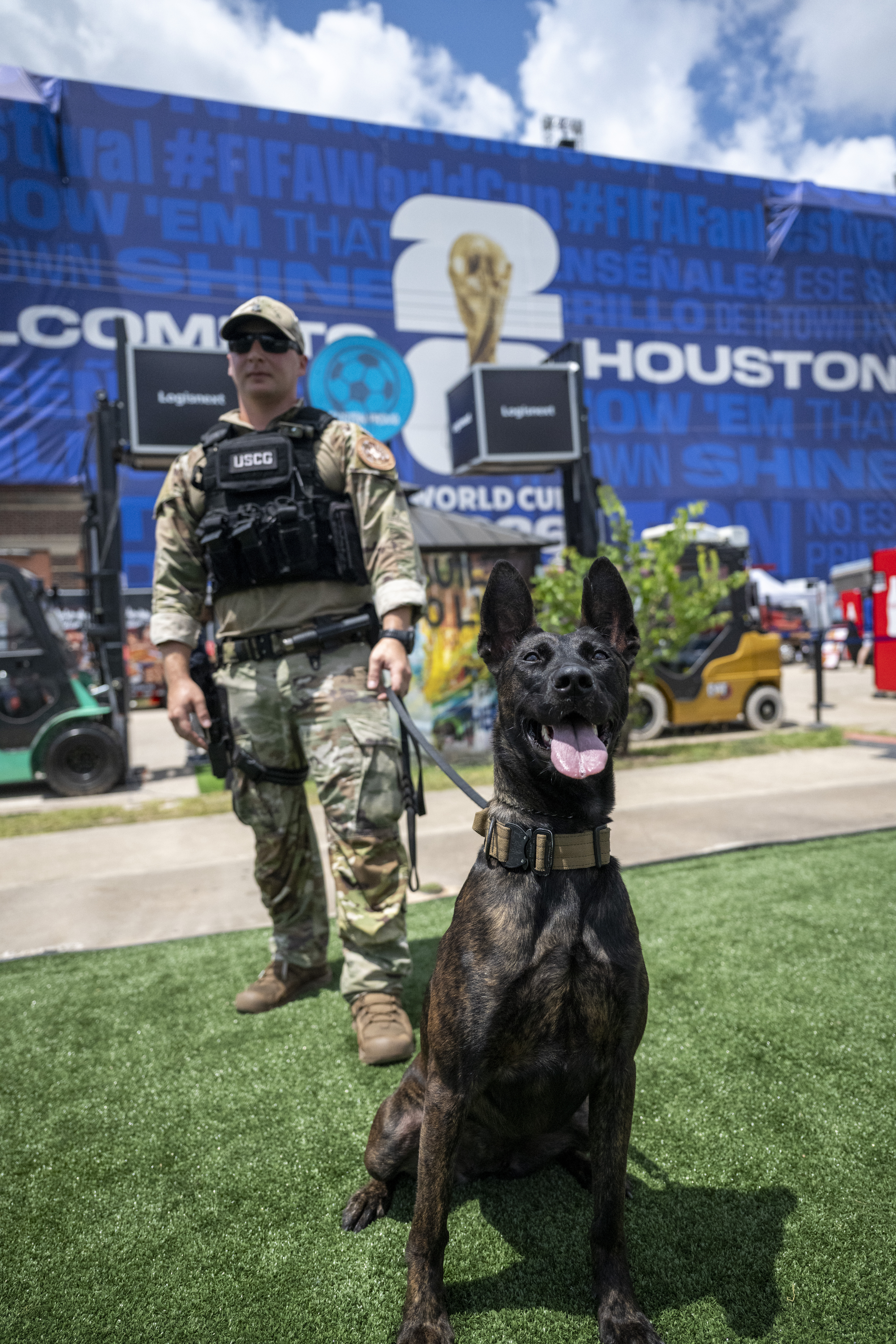 Coast Guard K-9 Gama, a Dutch Shepherd, conducts an explosive detection sweep with her handler at the FIFA Fan Fest in Houston.