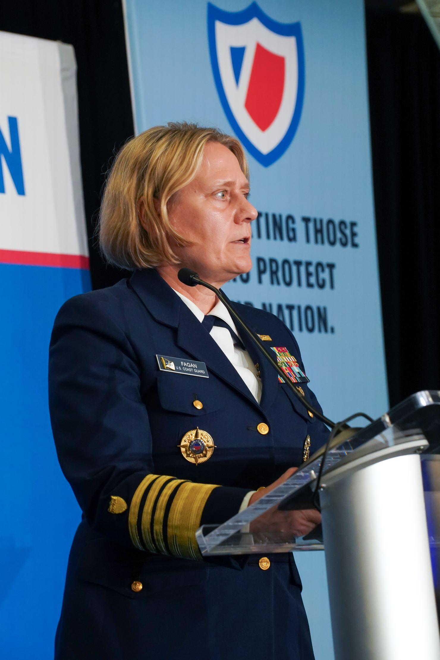 Admiral Linda Fagan speaking at a podium