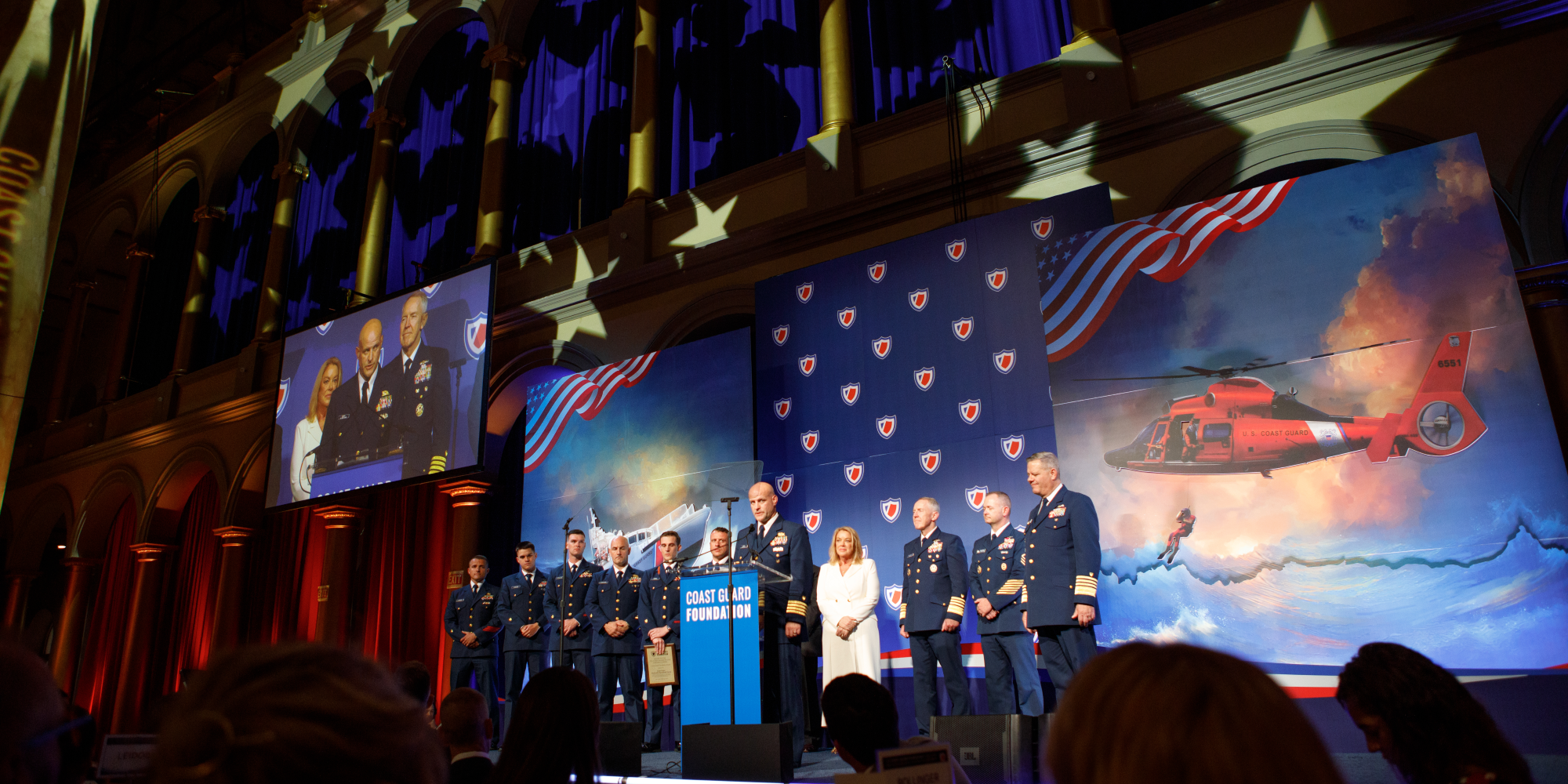 Coast Guard members on stage.