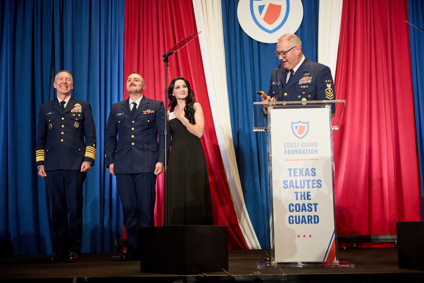 Several people standing on stage
