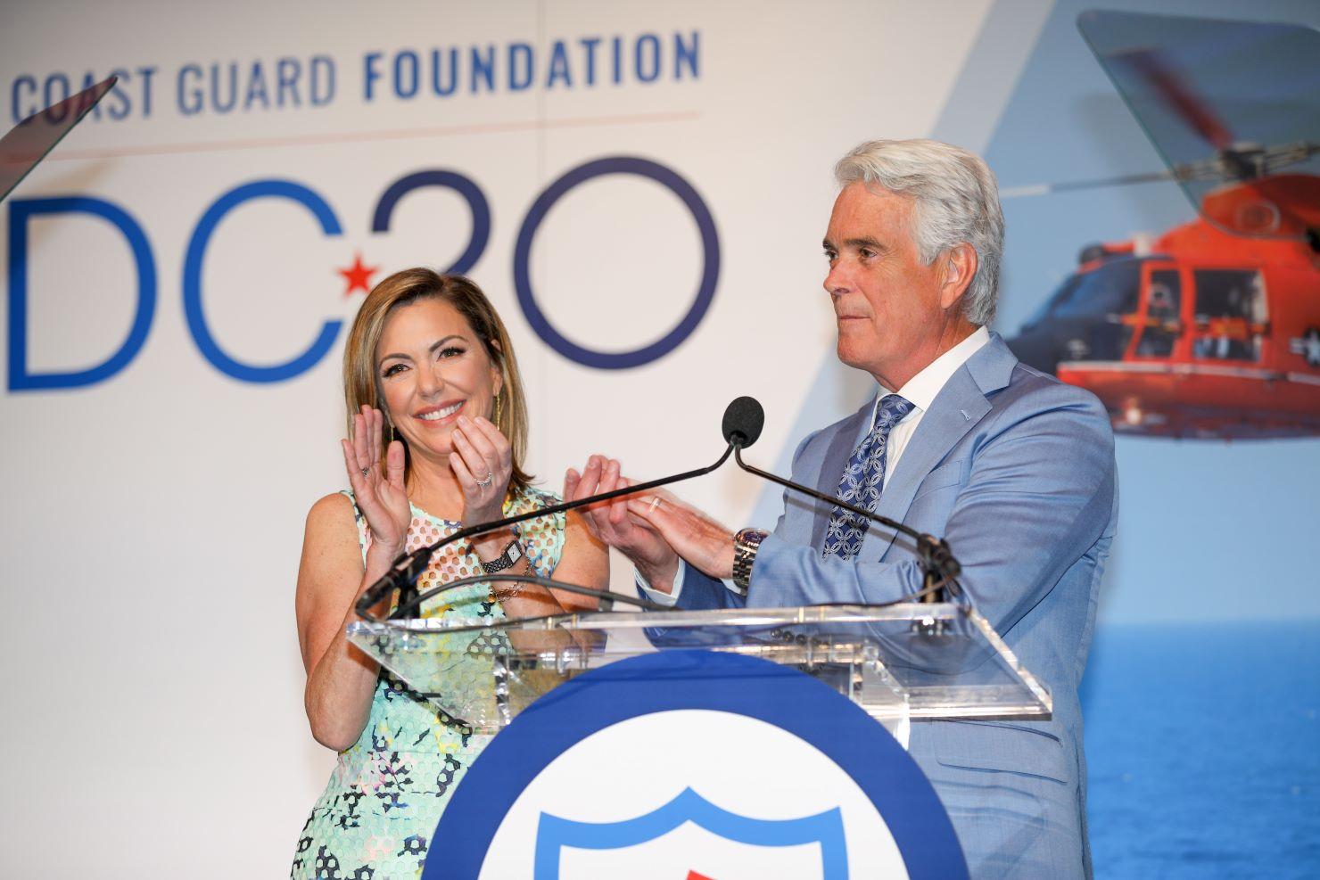 Man and woman at a podium.