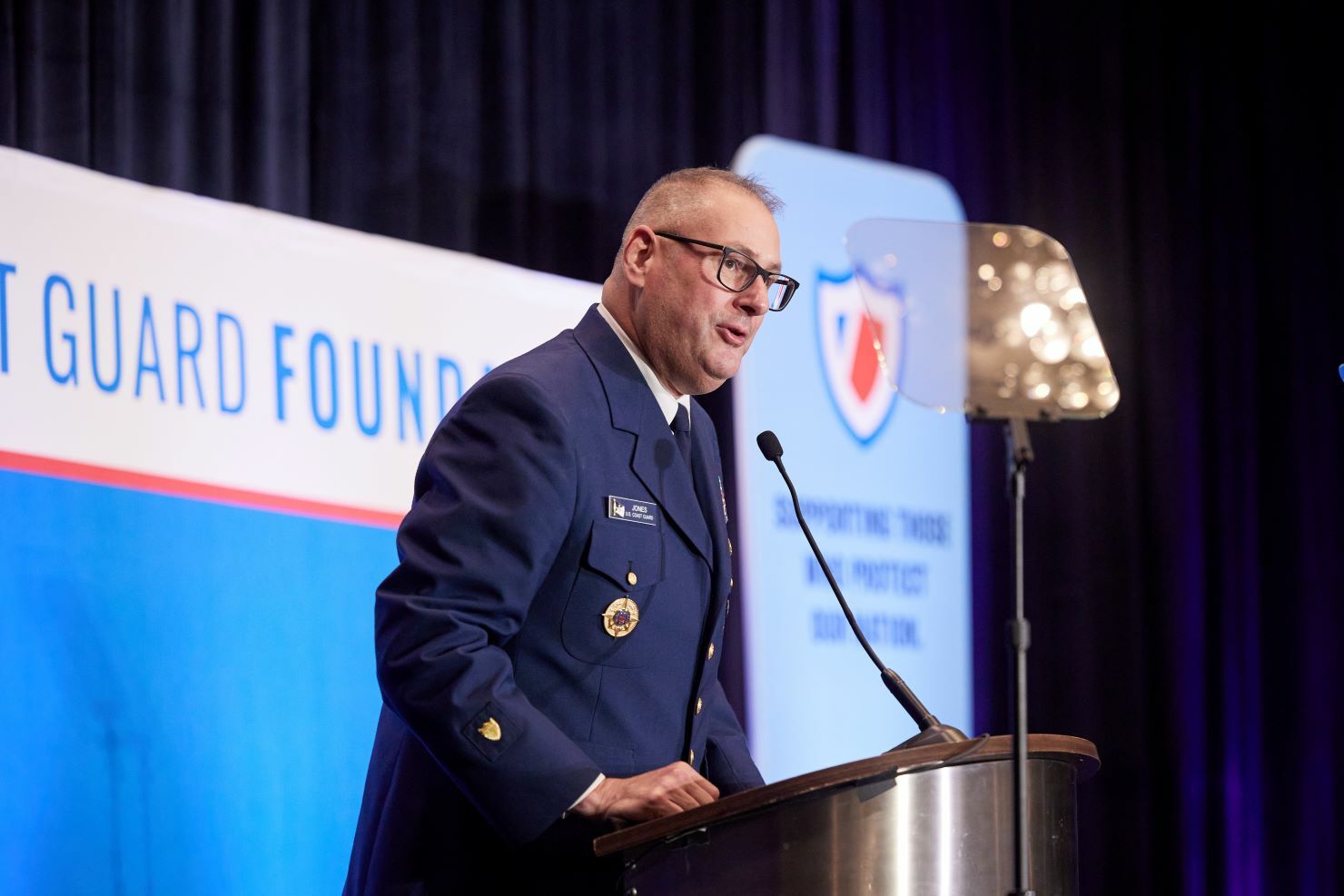 A man in uniform at a podium.